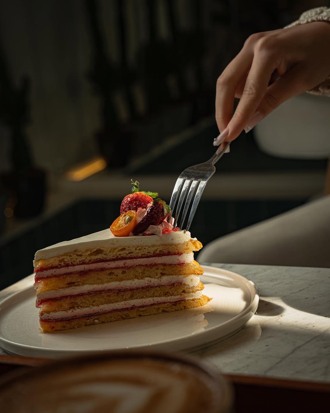 Strawberry cream layer cake, fork in hand