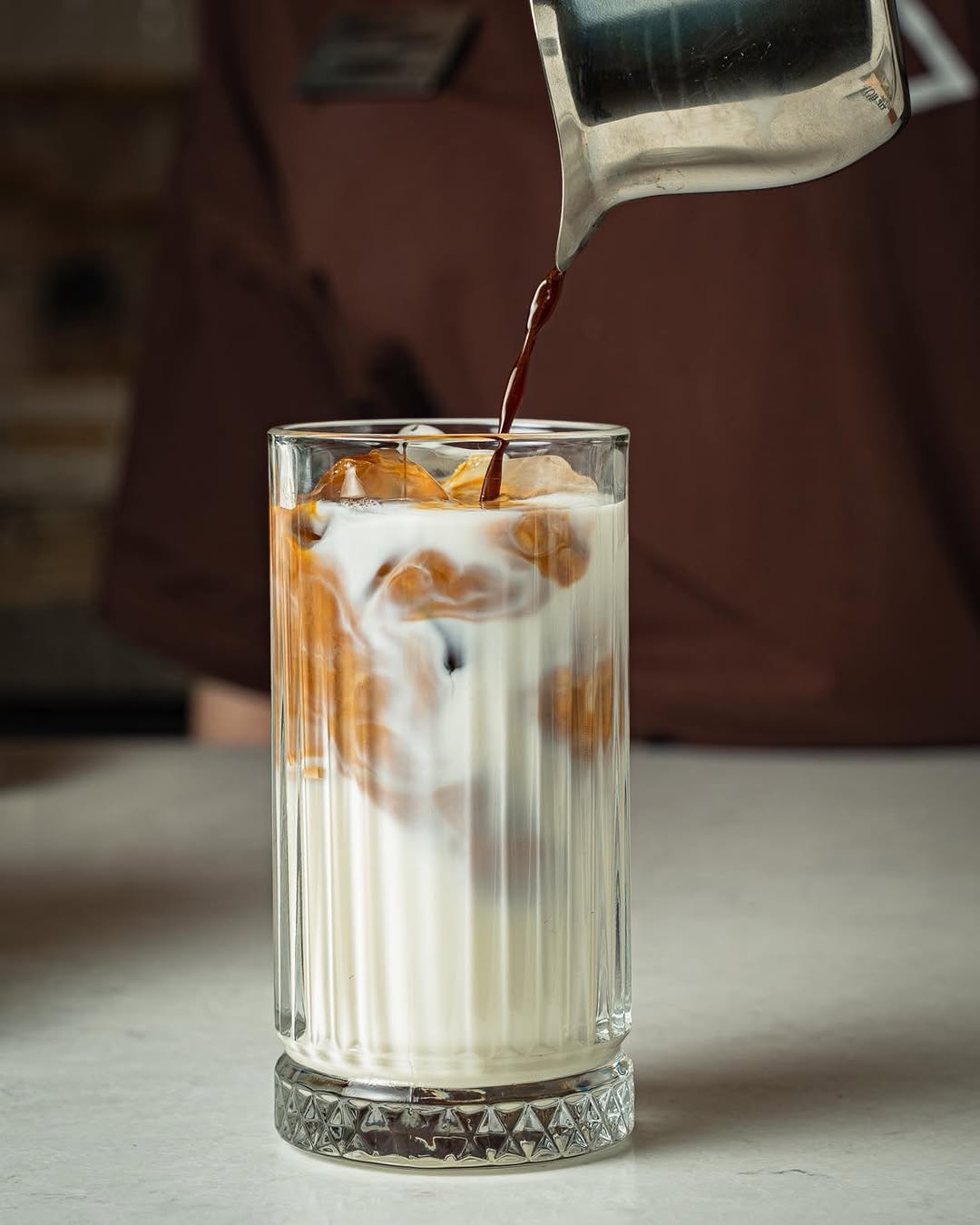 Iced latte being poured at Korhan Whitestone